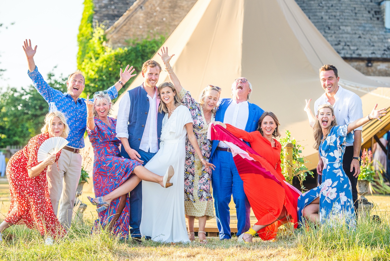 Happy wedding party with their tipi